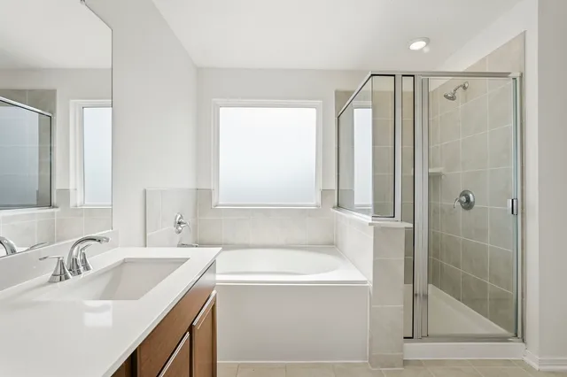 a bathroom with a granite countertop sink mirror and shower