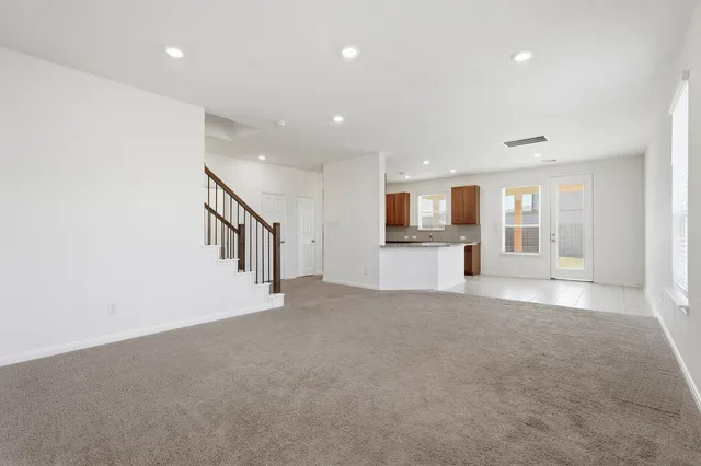 a view of empty room with wooden floor and window