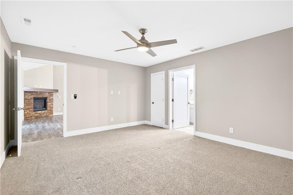 734 Sandstone Way Rostraver Township, PA 15012 - Photo 24 of 50 The primary bedroom is located on the main floor right off of the family living area. It has wall to wall carpeting and a walk-in closet.