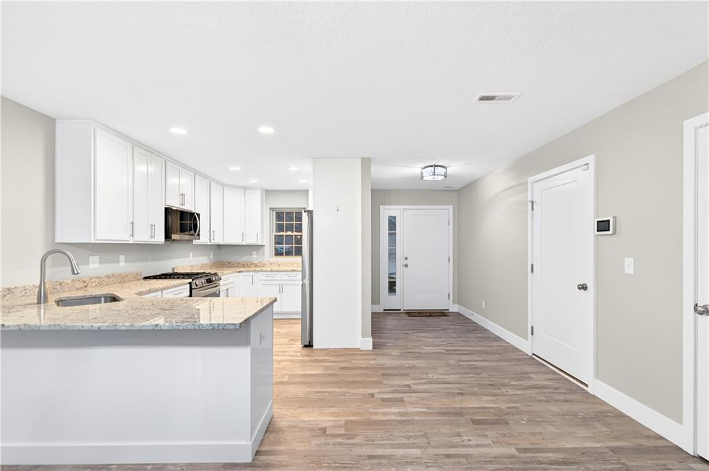 734 Sandstone Way Rostraver Township, PA 15012 - Photo 5 of 50 The chef's kitchen has granite counter tops with a pencil edge and a central single bowl sink with ample lighting.