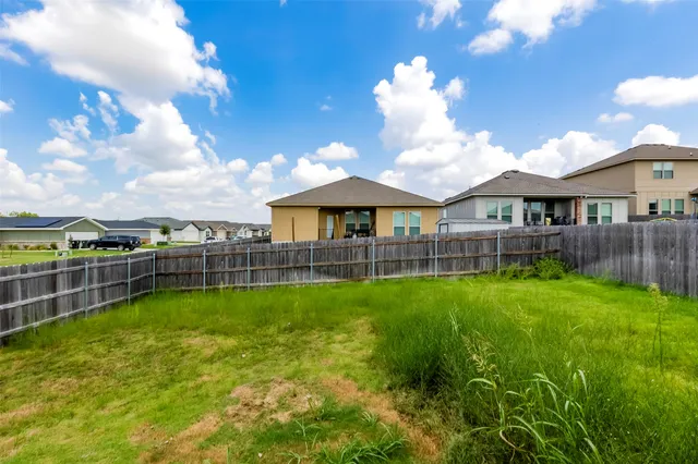a view of a house with a backyard