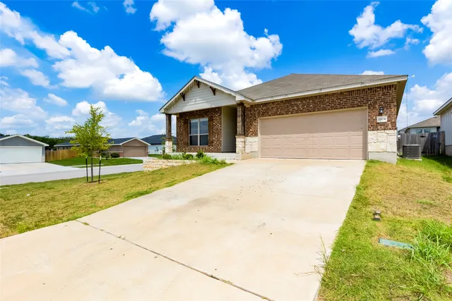 a view of a house with backyard and sitting area