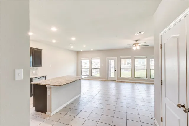 a view of a kitchen with a sink and a large window