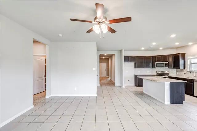 a view of kitchen with sink microwave and cabinets