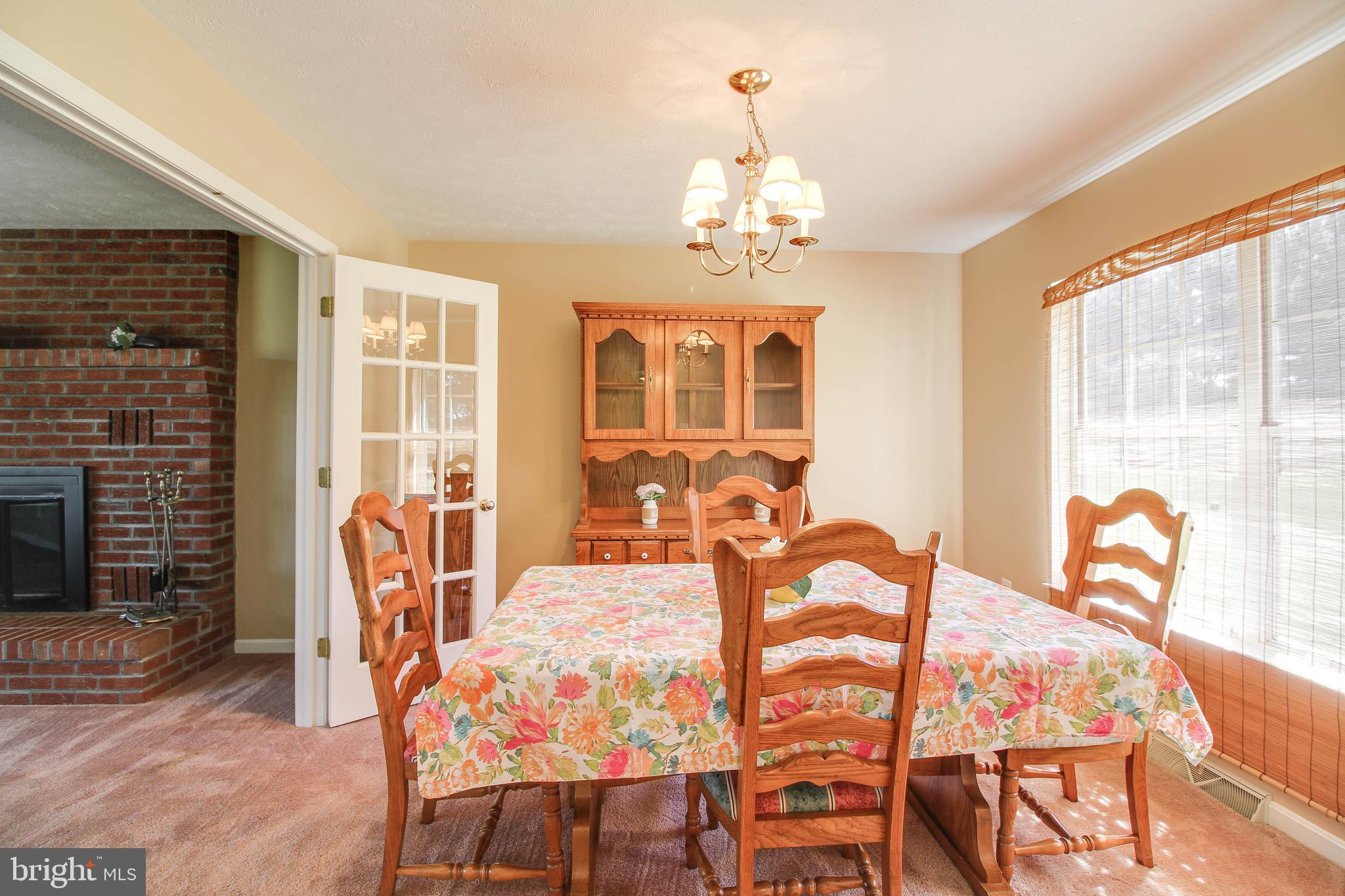 4709 Mt Carmel Road Hampstead, MD 21074 - Photo 8 of 44 a view of a dining room with furniture a chandelier and wooden floor