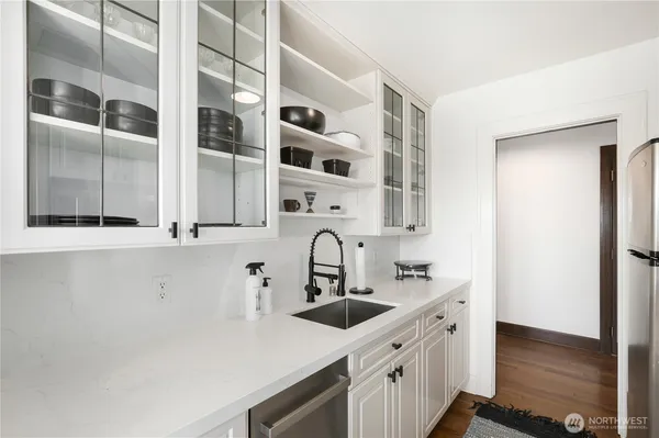 a kitchen with stainless steel appliances a sink and cabinets