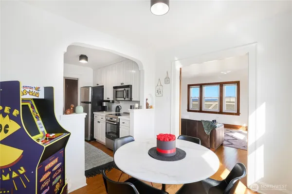 a view of a dining room with furniture and a kitchen