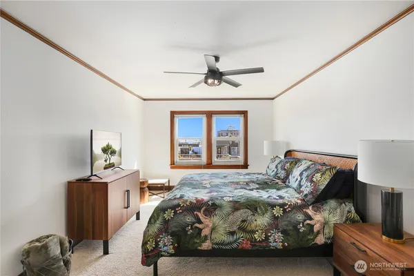 a bedroom with a bed and a window