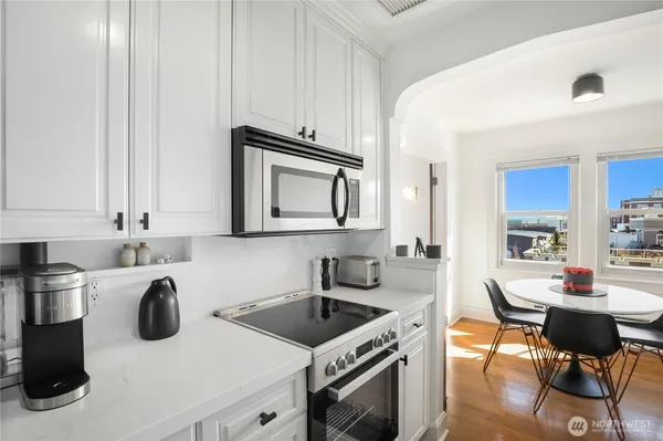 a kitchen with a stove a sink and a microwave