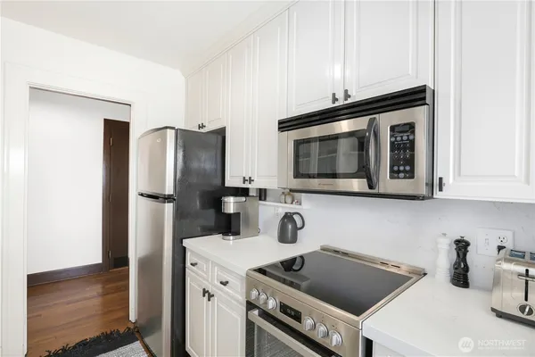 a kitchen with a refrigerator stove and microwave
