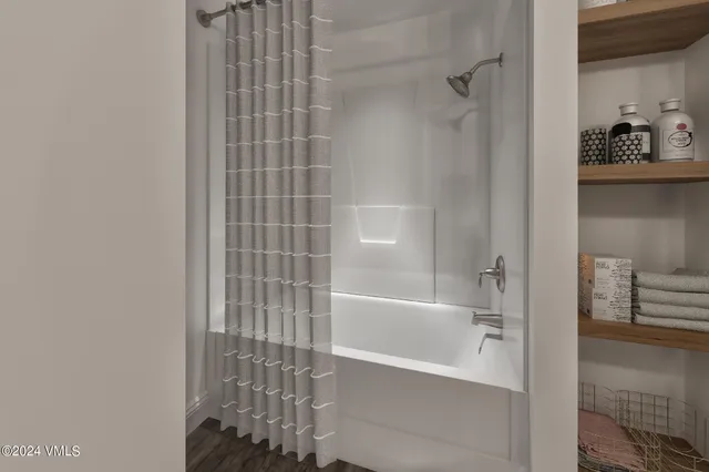 a bathroom with a bathtub and shower