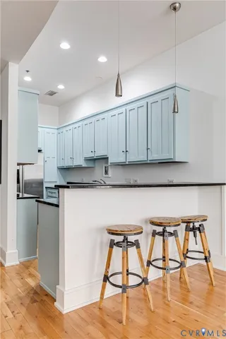 a kitchen with granite countertop white cabinets and stainless steel appliances