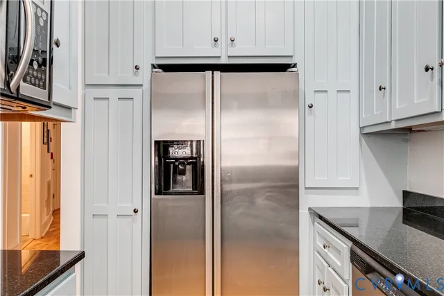 a kitchen with stainless steel appliances granite countertop a refrigerator and a stove