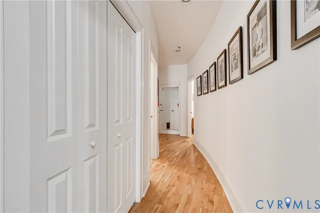 a view of a hallway with wooden floor and entryway