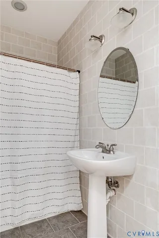 a bathroom with a sink a mirror and a shower