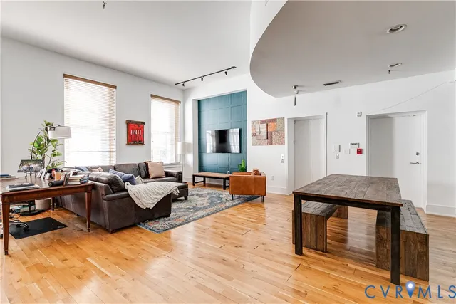 a living room with furniture window and wooden floor