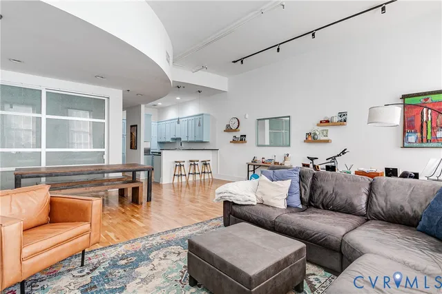 a living room with furniture and a wooden floor