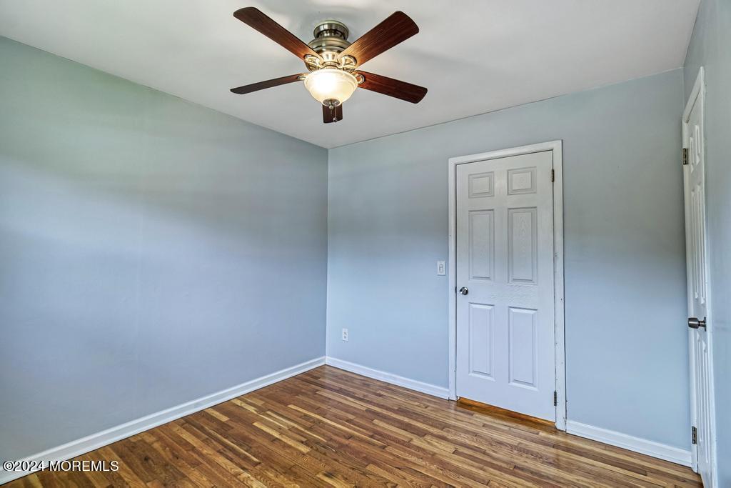 120 Frede Drive Brick, NJ 08724 - Photo 20 of 55 an empty room with wooden floor and a ceiling fan