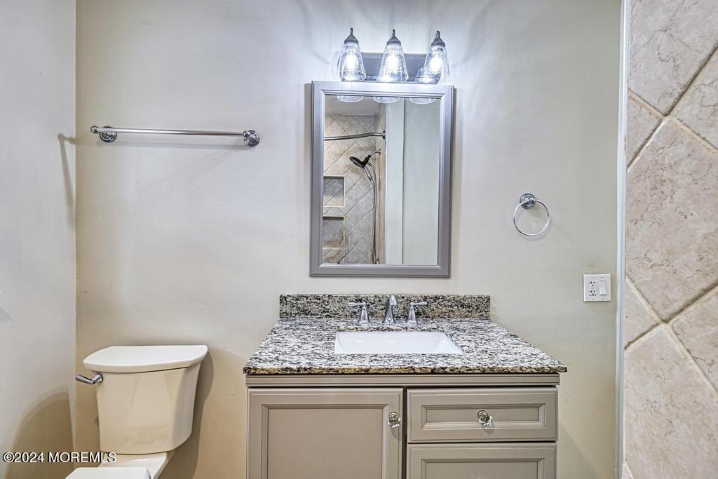 120 Frede Drive Brick, NJ 08724 - Photo 30 of 55 a bathroom with a granite countertop sink a toilet and a mirror