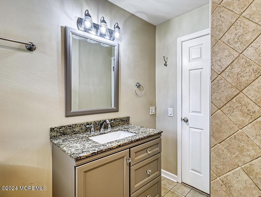 120 Frede Drive Brick, NJ 08724 - Photo 31 of 55 a bathroom with a granite countertop sink and a mirror