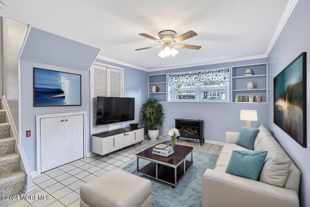 120 Frede Drive Brick, NJ 08724 - Photo 35 of 55 a living room with furniture a flat screen tv and a fireplace