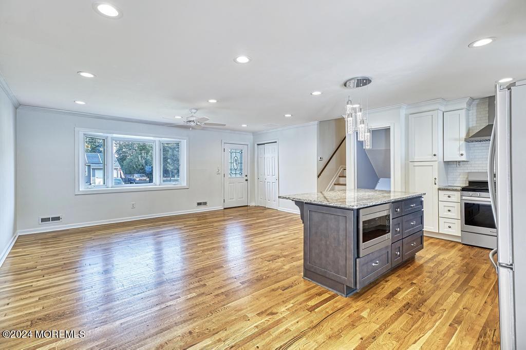120 Frede Drive Brick, NJ 08724 - Photo 4 of 55 a kitchen with stainless steel appliances granite countertop a stove and a wooden floors