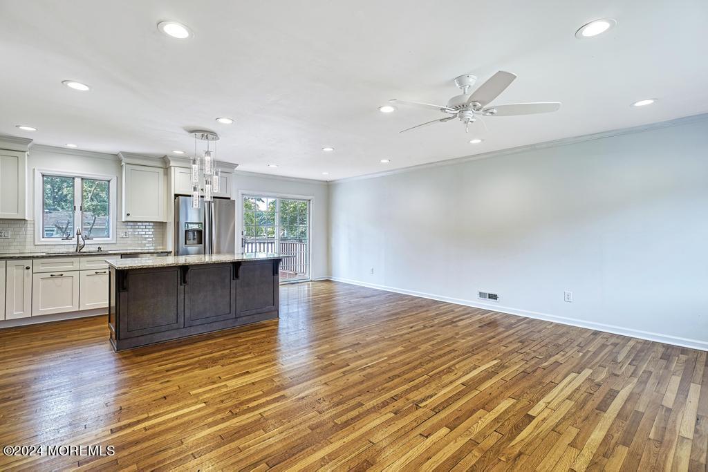 120 Frede Drive Brick, NJ 08724 - Photo 8 of 55 a large kitchen with stainless steel appliances granite countertop a large counter top a sink and a chandelier
