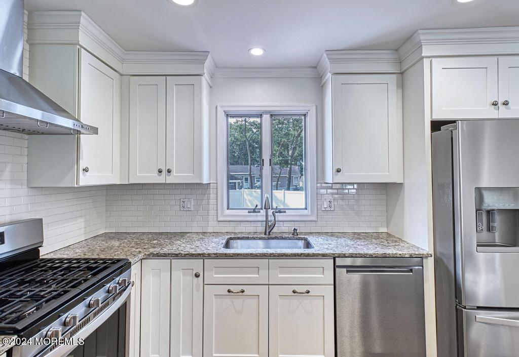120 Frede Drive Brick, NJ 08724 - Photo 9 of 55 a kitchen with granite countertop a sink stove and refrigerator