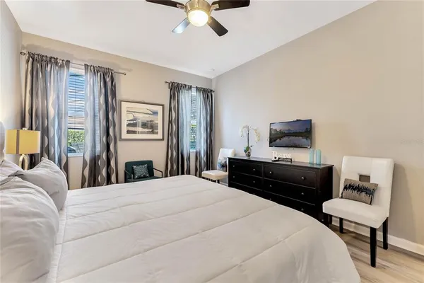 a bedroom with a bed window and a television