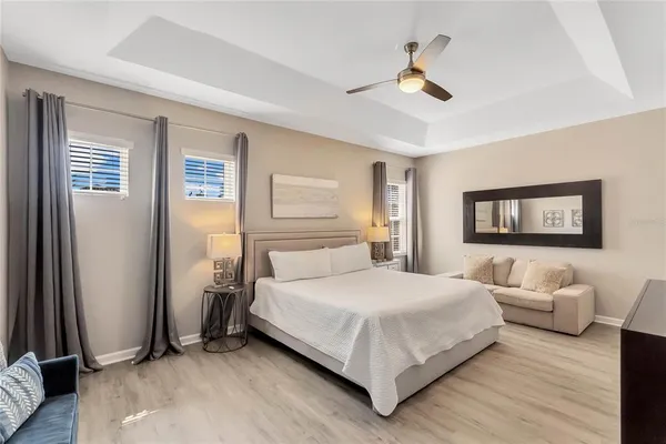a bedroom with a bed and a chandelier
