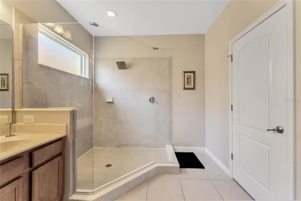 a bathroom with a shower and a sink