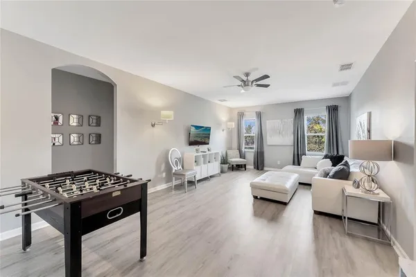 a living room with furniture wooden floor and a table