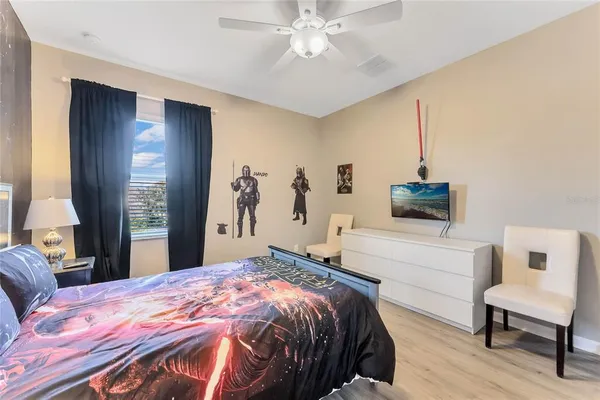 a bedroom with a bed and a television