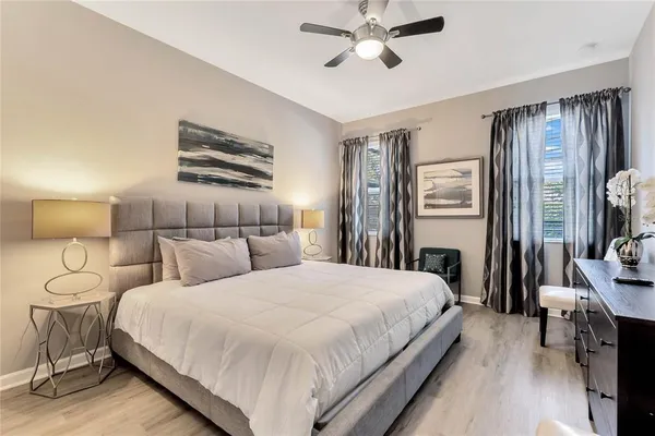 a bedroom with a bed and a chandelier