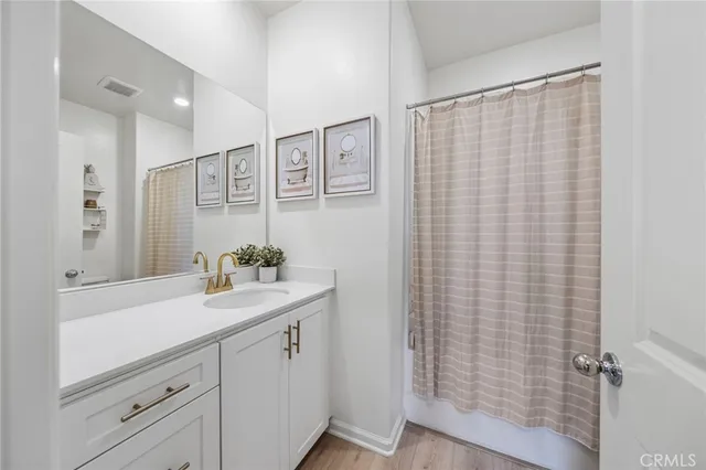 a bathroom with a sink a mirror and a shower curtain