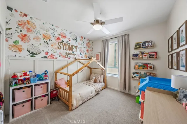 a bedroom with furniture and book shelf