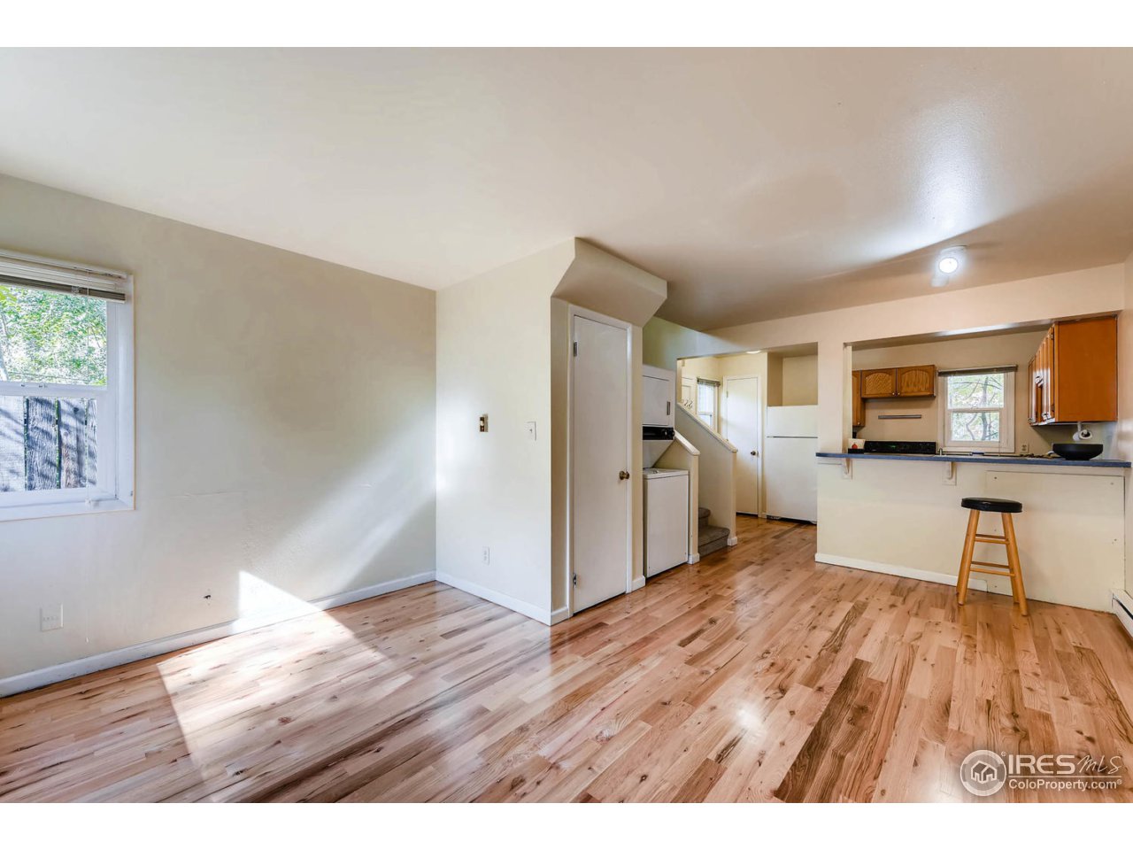 1623 18th Street Boulder, CO 80302 - Photo 8 of 11 a view of a living room hardwood floor and a kitchen