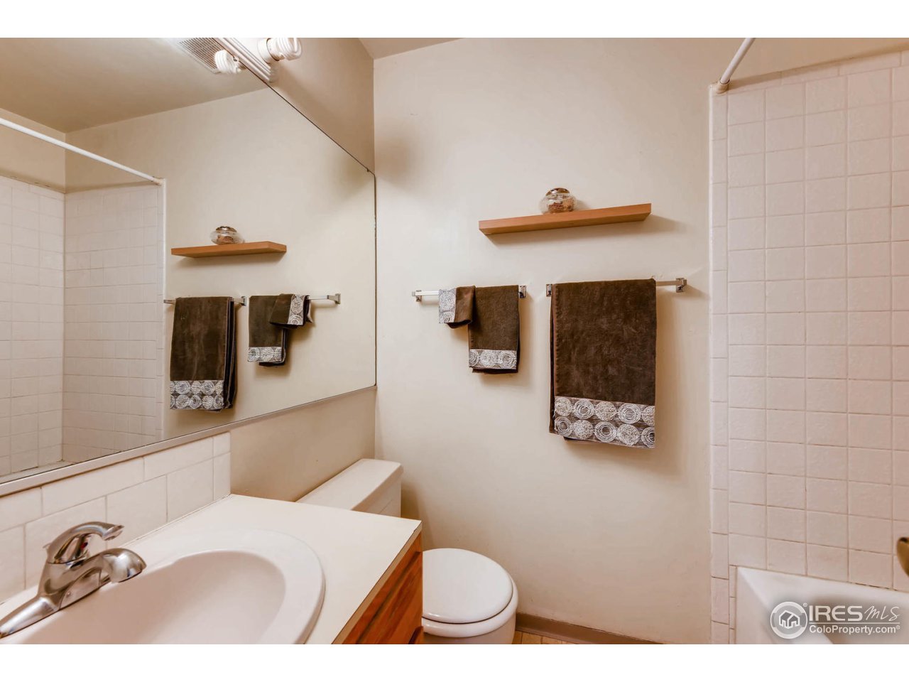 1623 18th Street Boulder, CO 80302 - Photo 10 of 11 a bathroom with a sink a toilet and mirror