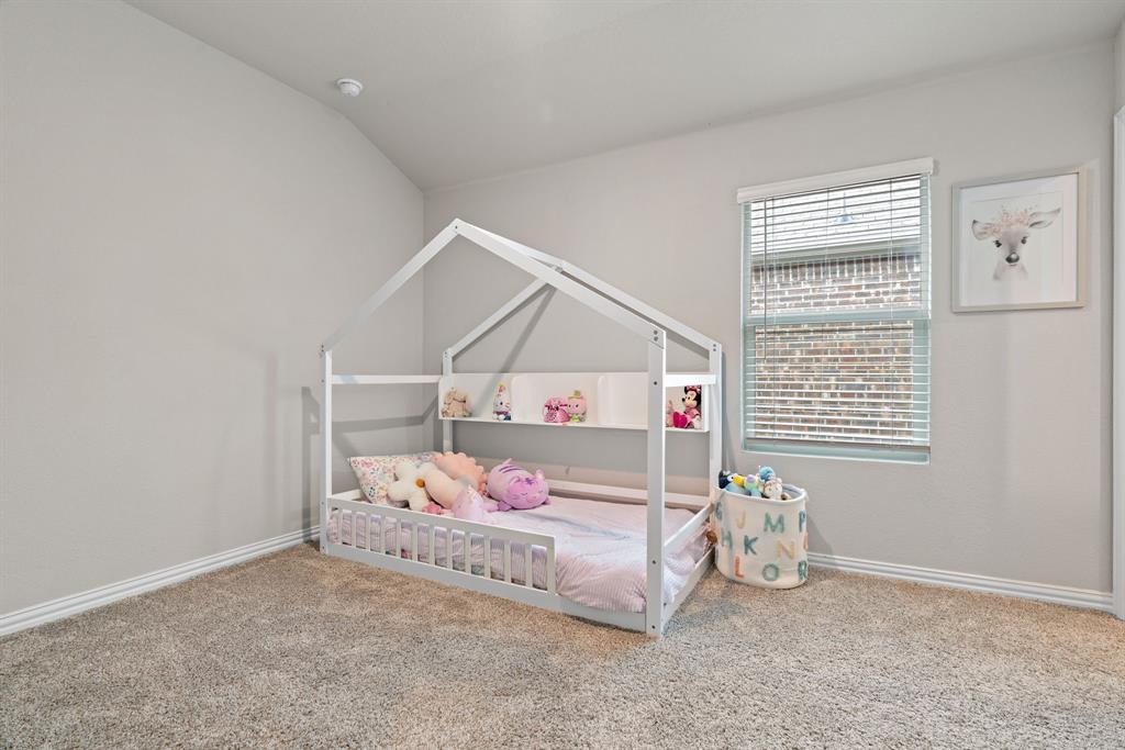 3112 Kingsgarden Road Denton, TX 76207 - Photo 24 of 38 Carpeted room featuring a single window with blinds, light gray walls, white baseboards, and a vaulted ceiling