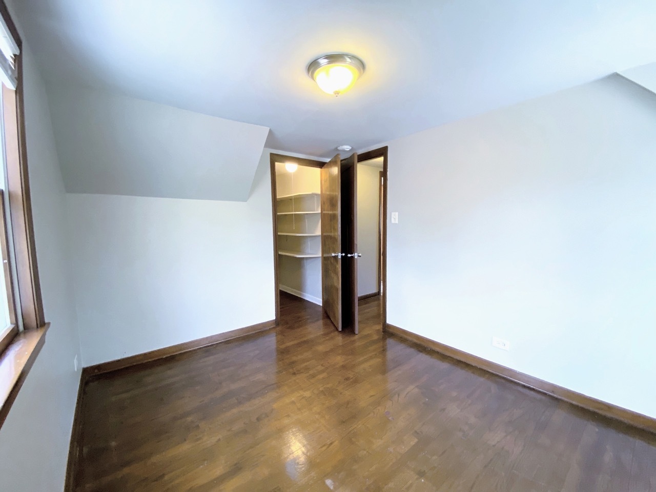 3003 Longfellow Avenue Hazel Crest, IL 60429 - Photo 12 of 19 a view of an empty room with a window and wooden floor