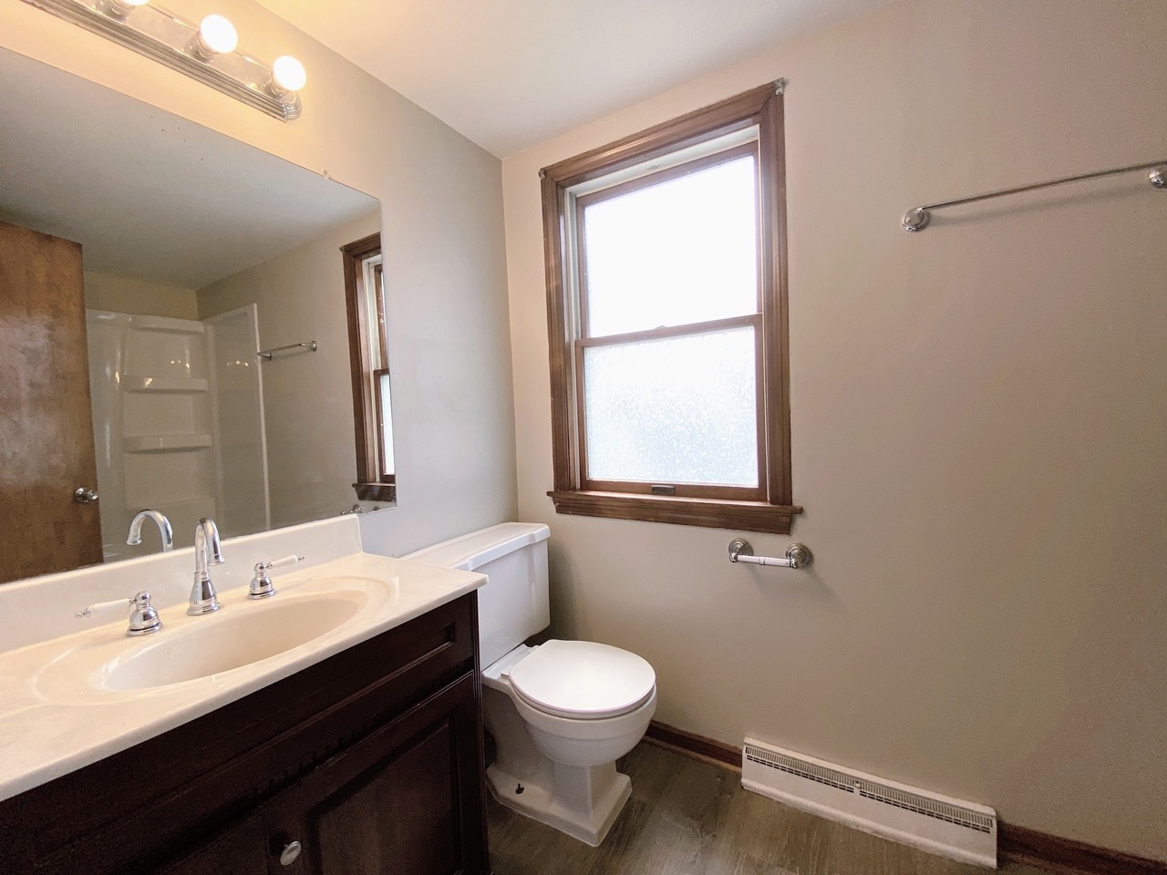 3003 Longfellow Avenue Hazel Crest, IL 60429 - Photo 13 of 19 a bathroom with a toilet a sink a mirror and a window