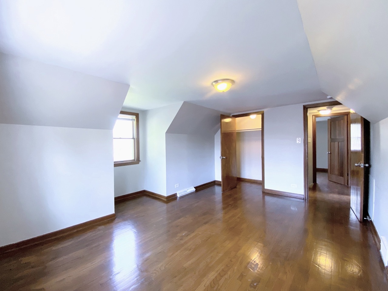 3003 Longfellow Avenue Hazel Crest, IL 60429 - Photo 15 of 19 an empty room with wooden floor and windows