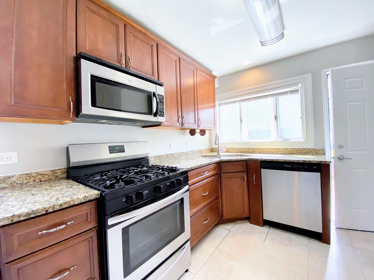 3003 Longfellow Avenue Hazel Crest, IL 60429 - Photo 3 of 19 a kitchen with stainless steel appliances granite countertop a stove microwave and sink