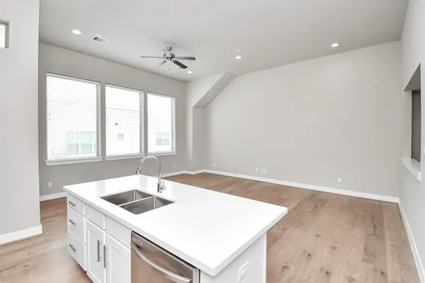 a view of kitchen with sink microwave and refrigerator