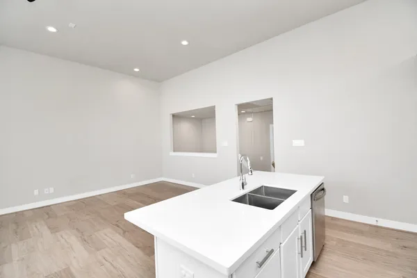 a kitchen with stainless steel appliances granite countertop a sink stove microwave and refrigerator