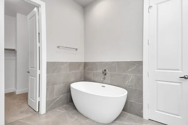 a bathroom with a bathtub and shower