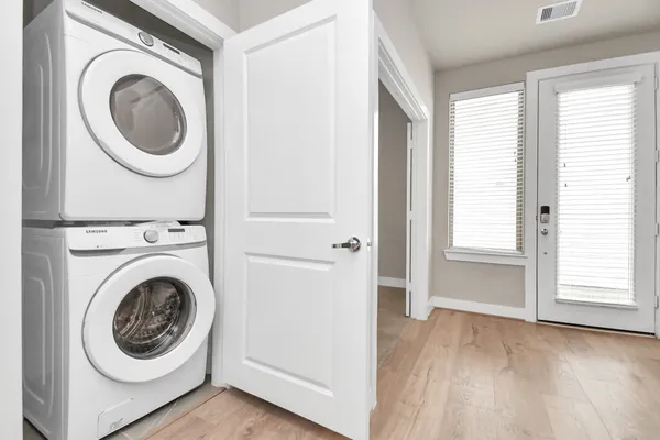 a view of a hallway with washer and dryer