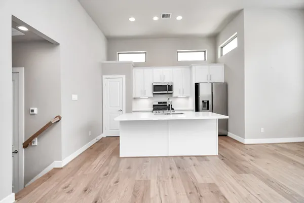 a view of a kitchen with microwave and cabinets