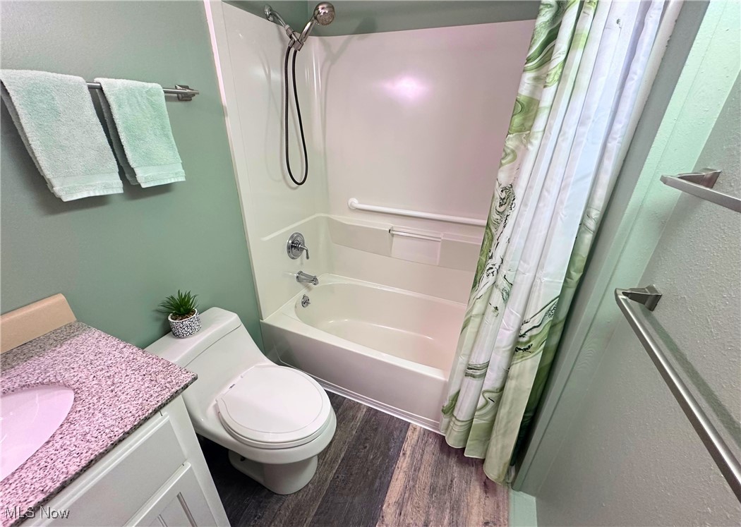 157 Birch Road Painesville, OH 44077 - Photo 21 of 41 Full bath featuring wood finished floors, shower / tub combo with curtain, vanity, and toilet