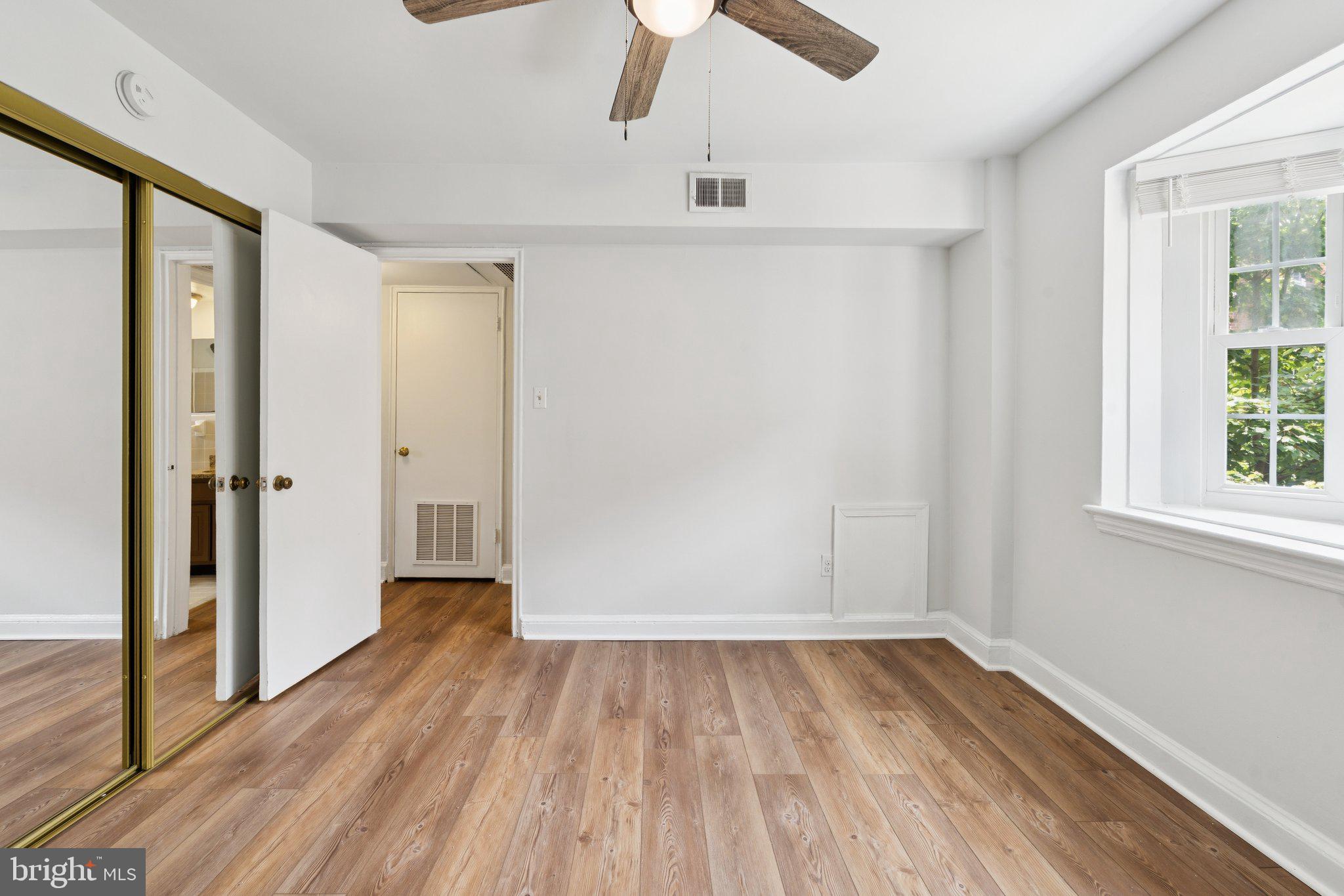 2107 North Scott Street, Unit 70 Arlington, VA 22209 - Photo 13 of 19 wooden floor in an empty room with a window